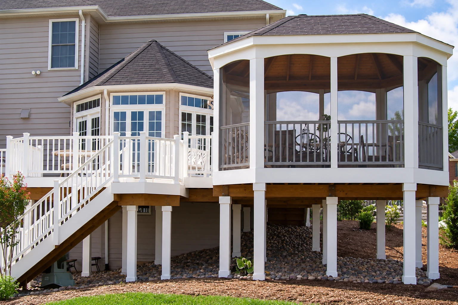 A raised screened room with a polygonal roof and white supports, connected to a house by a staircase.